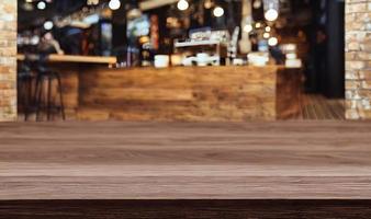 Empty wooden table in front of its background. photo