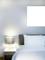 Simple, Comfortable bedding and stylish lamp in modern design bedroom,  white blank hanging picture for copy space with clipping path photo
