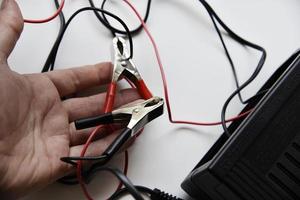 Red and black battery clips. A charger for car batteries. photo