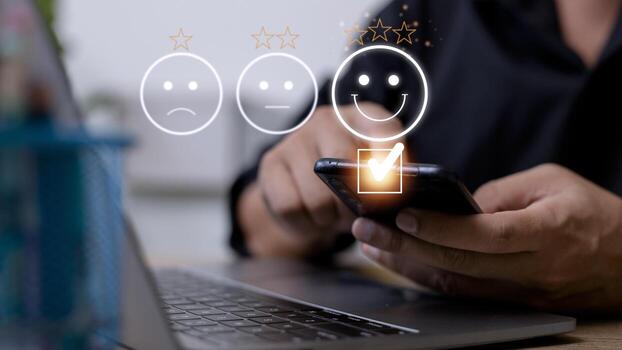 Customer service evaluation concept. using a smartphone is pressing face emoticon smiling in satisfaction on virtual touch screen. photo