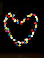 Bokeh with the shape of a heart with multi colors photo