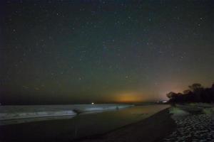 Night sky with stars and sand beach photo