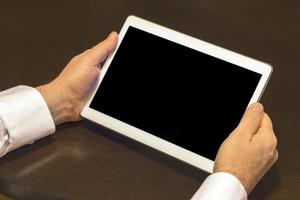 Businessman hands are holding the touch screen device. photo