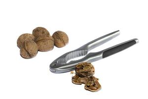 Group of walnuts and broken walnuts with a Nutcracker, isolated  on white background photo
