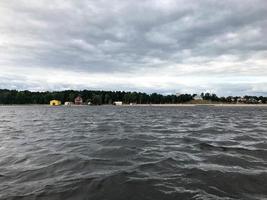 Landscape of the nature of the horizon line with a view of the shore, water with waves from the middle of the lake in the cold cloudy weather photo