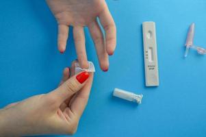 Positive test result by using rapid test for COVID-19, quick fast antibody point of care testing. Lab performing rapid diagnostic test for antibodies to detect presence of antigens COVID-19 disease photo
