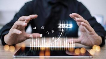 Business and Technology target set goals and achievement in 2023 new year resolution statistics graph rising revenue, planning to start up strategy, icon concept photo