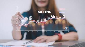 Concept of tax payment optimization business finance, people with taxes icon on technology screen, income tax and property, background for business, individuals and corporations such as VAT