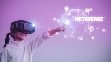 Metaverse Technology concepts. Little girl and experiences of metaverse virtual world on colorful background photo