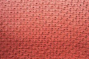 Knitted soft coral texture with beautiful pattern. Beautiful background. Copy space. photo