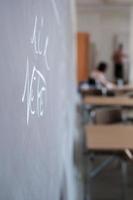 pizarra con inscripciones hechas con tiza blanca, en un salón de clases. concepto de educación foto