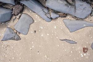 Sand and stones on the beach, can be used as a background. Copy space. Top view. photo