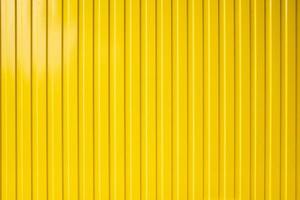 Yellow metal fence. Bright textured background. Copy space. photo