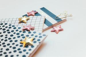 Desktop feminine composition. Notepads and stars photo