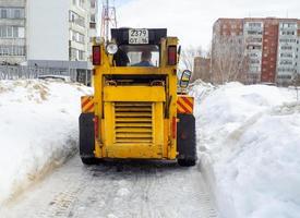 snow removal.Street photo. Big snowdrifts in the city. The path after the passage of the snowplow. photo