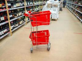 Trolley in a hypermarket. Shelves in the store. Laying out goods in a supermarket. photo