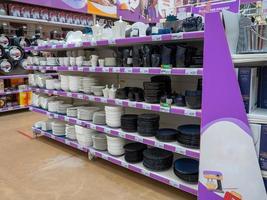 Shelves in the store. Sale of dishes. Kitchenware. Laying out goods in a supermarket. photo