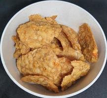 This is a close up photo of tempe chips in a small bowl.