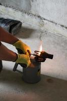 Gasoline blowtorch with a burning fire, the use of a blowtorch in construction. photo