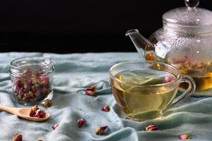 Hot Rose Tea Was Poured From Kettle into Teacup and Served on Table in Restuarant photo