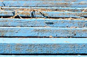 The texture of wooden boards is blue with seams horizontally painted with natural paint. The background photo