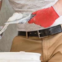 Lime plaster on a spatula, repair and decoration work with lime plaster, two dirty spatulas. photo