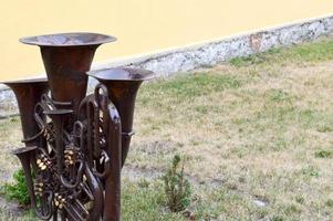 Iron brown musical trumpet, a pipe for playing music on a background of green grass photo