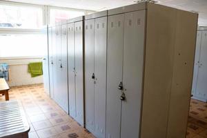 Room, locker room for workers with individual lockers for changing clothes in an industrial plant photo