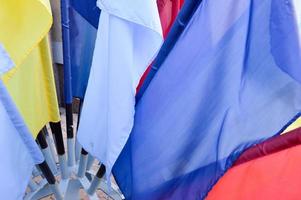 Texture of multi-colored festive red, blue, yellow flags made of fabric. The background. photo