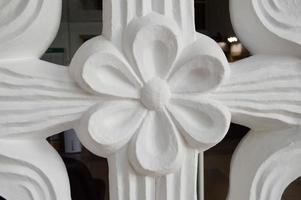 Texture of a white flower with petals of relief bulk from a decorative plaster of a stone with a pattern. The background photo