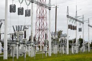 Metal transmission line with the components of the electric network, the system of power equipment for the transmission of electricity, electric current with the transformer at the power station photo