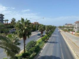 Large wide multi-lane highway road with palm trees on the sides in a warm tropical country southern resort photo