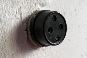 Retro socket for connecting a radio on a white wall. Close-up. photo