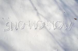 Word of snow and three large letters NO written on a snowbank. Spring waiting concept. Copy space. Creative idea. photo