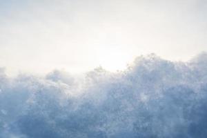 Fluffy snow against the sky, on a winter evening, at sunset. Copy space. Abstract background. Bottom view. photo