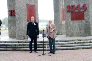 Old man grandfather veteran of World War II in medals and decorations stands next to the monument on the day of victory Moscow, Russia, 05.09.2018 photo