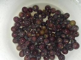 Squeezing grape juice with a screw manual meat grinder photo