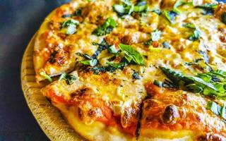 Italian garlic pizza with basil herbs and tomato sauce Mexico. photo