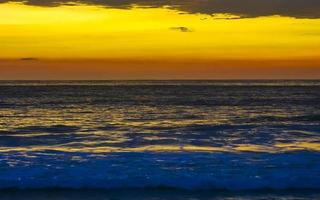 Colorful golden sunset big wave and beach Puerto Escondido Mexico. photo