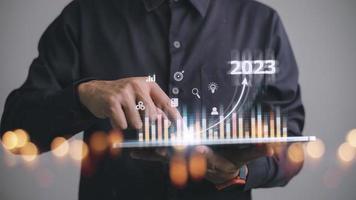 Business and Technology target set goals and achievement in 2023 new year resolution statistics graph rising revenue, planning to start up strategy, icon concept photo