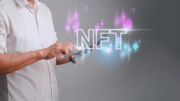 businessman finger touch virtual screen, NFT token digital crypto art blockchain technology concept photo