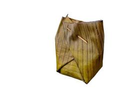 Botok Indonesian traditional Javanese food. Botok is made from grated coconut, anchovies, mlanding, tempe then wrapped in banana leaves and steamed. Presented on a white background photo