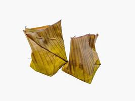 Botok Indonesian traditional Javanese food. Botok is made from grated coconut, anchovies, mlanding, tempe then wrapped in banana leaves and steamed. Presented on a white background photo