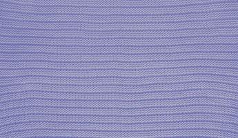 Texture of smooth knitted sweater with pattern. Handmade knitting wool or cotton fabric texture. Background of knitting patterns with horizontal stripes. photo