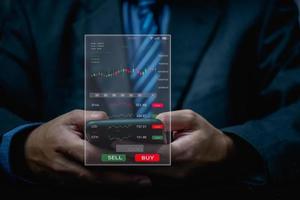 Businessman using mobile smartphone working with stock market investments to report analysis trading data. Statistic exchange graph on screen. Financial stock market. photo