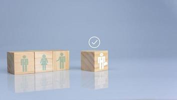 Concept of Business and HR for leadership and team leader. One cube wood block out in front  Different and stand out from the group photo