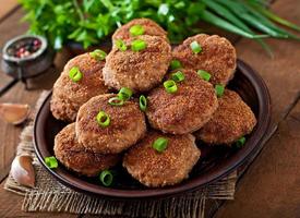 Juicy delicious meat cutlets on a wooden table in a rustic style. photo