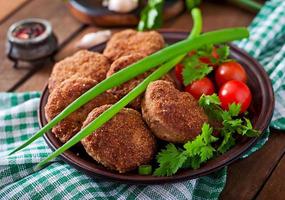 Juicy delicious meat cutlets on a wooden table in a rustic style. photo