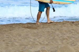 A man walks barefoot on the sand by the sea photo