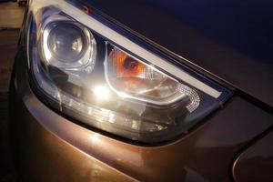 Car headlight close up. Modern lighting devices of luxury car. photo